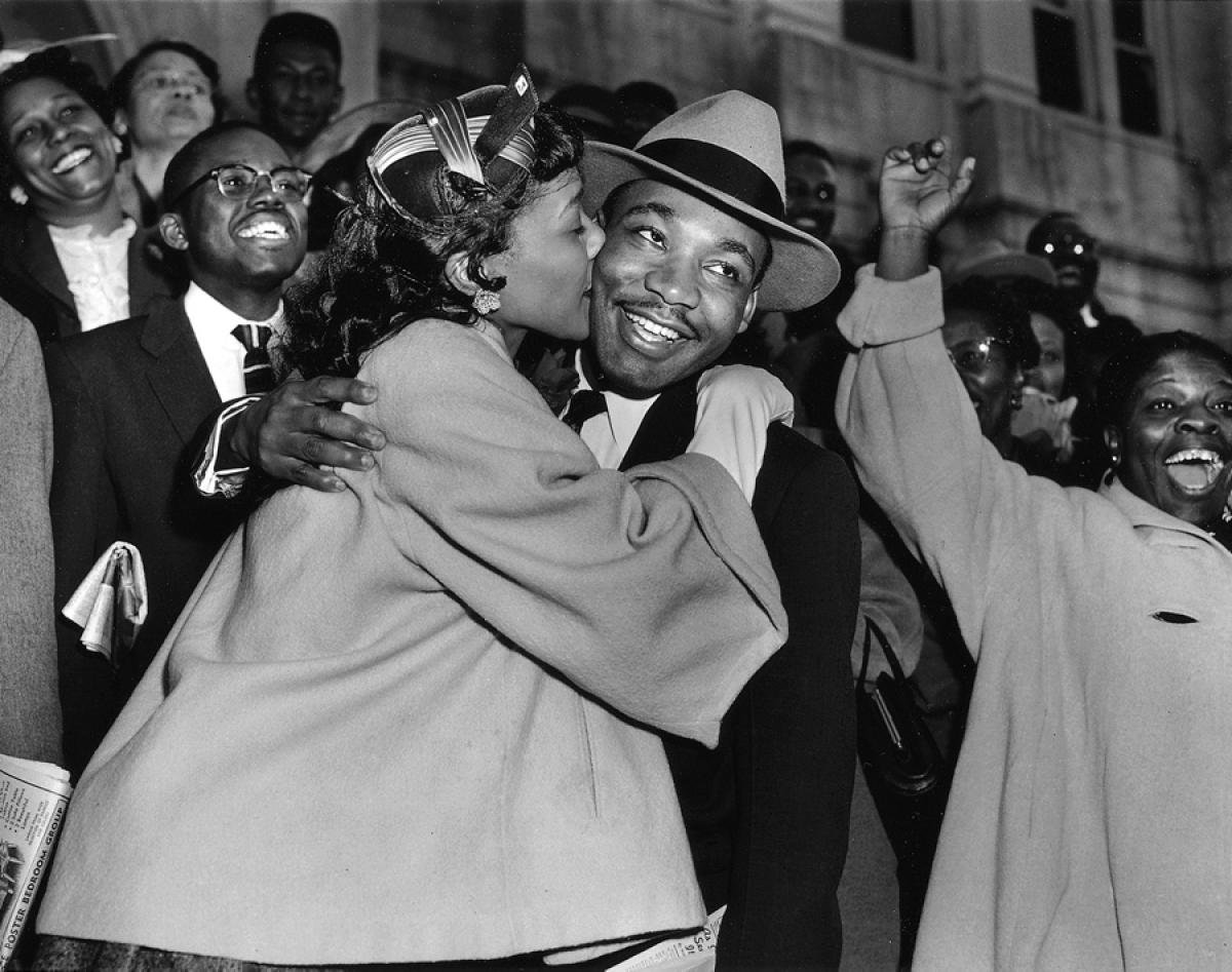 In 1956, Coretta embraces Martin after a courtroom victory, joy lighting the civil rights fight.